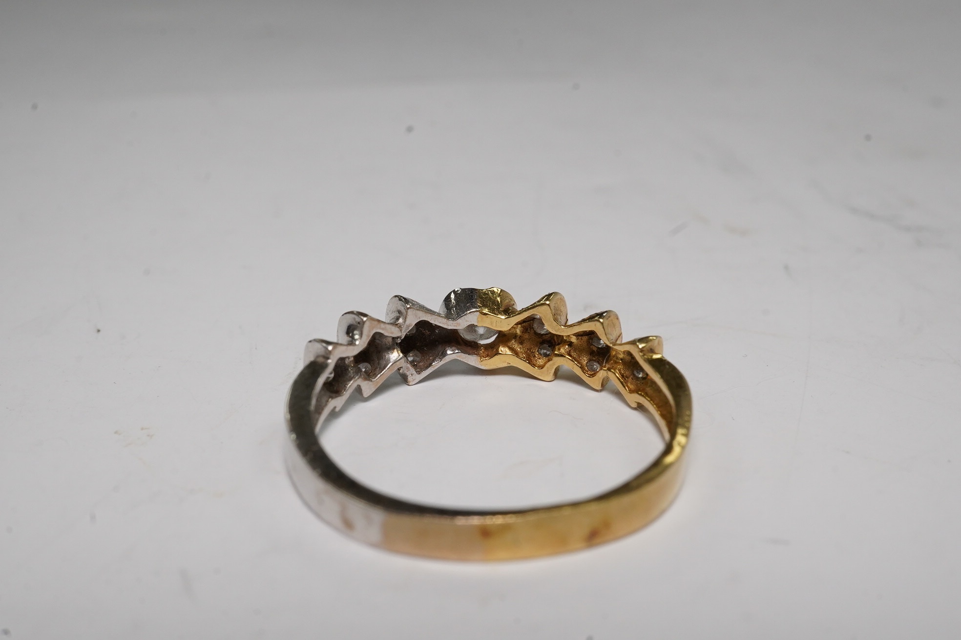 A yellow and white metal and seventeen stone diamond cluster set half hoop ring, size O/P, gross weight 3.3 grams. Condition - fair.